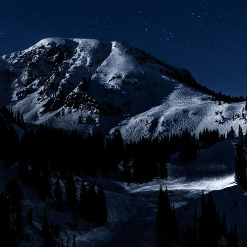 A night view of a snowy mountain under a starry sky at Alta Ski Area in Utah.
