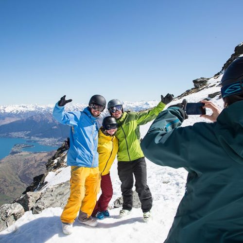 A skiing family posing for a picture at Coronet Peak + The Remarkables in New Zealand.