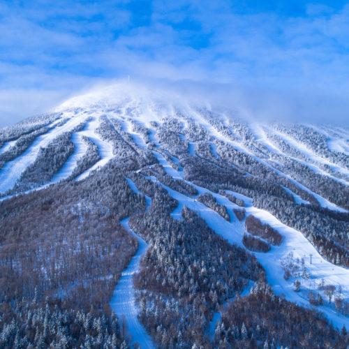 An aerial view of Sugarloaf's ski slopes in Maine. Access this incredible ski destination with your Mountain Collective pass.