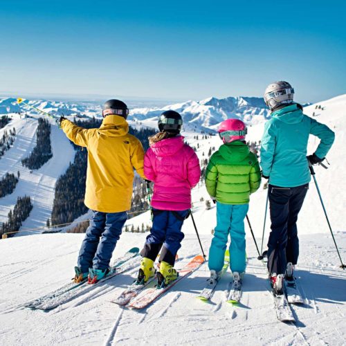 A family of skiers planning their run