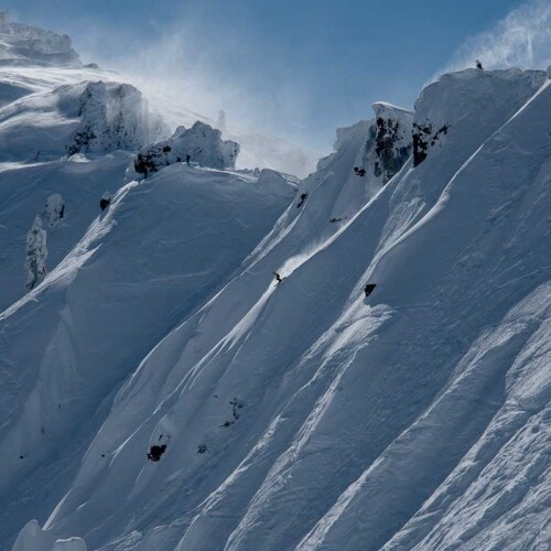 Skiers looking down a steep run at Tahoe's Sugar Bowl. Experience big mountain skiing with Mountain Collective.
